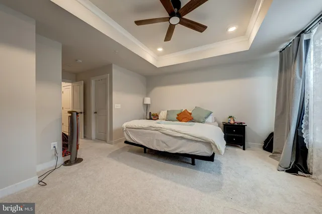 a bedroom with a bed and a ceiling fan