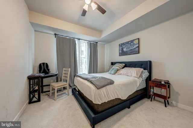 a bedroom with a bed and a desk