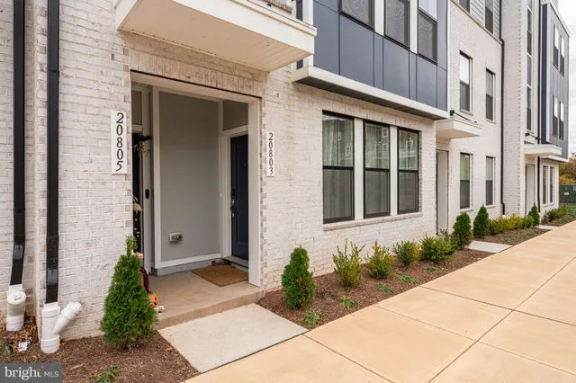 a front view of a brick house with a yard