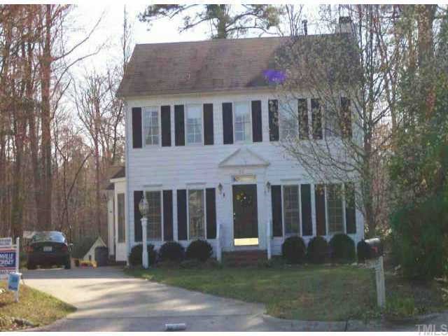 5521 Banwell Place Raleigh, NC 27613 - Photo 1 of 1 a view of a white house with a large windows and a yard with plants and large trees