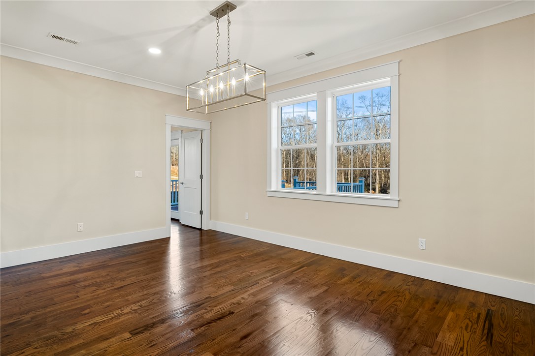 303 Regency Circle Anderson, SC 29625 - Photo 25 of 50 This inviting room features warm hardwood floors and abundant natural light through large windows.