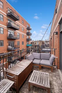 a roof deck with wooden floor and fence