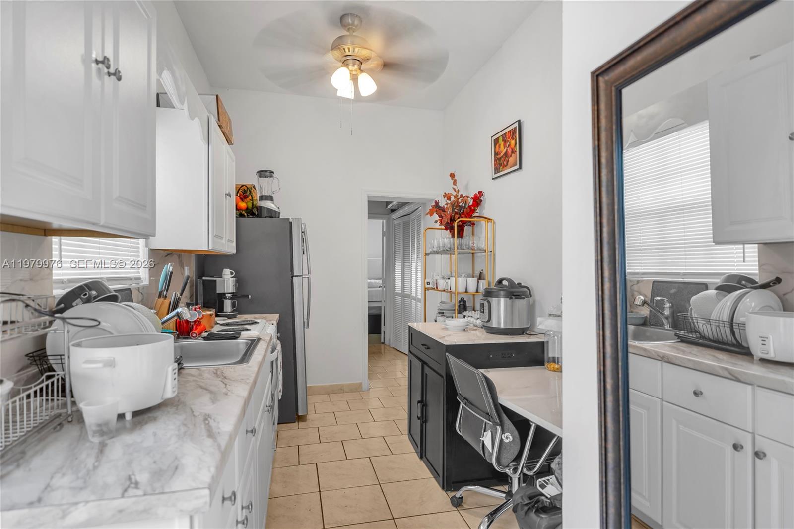 2900 Southwest 19th Street Miami, FL 33145 - Photo 13 of 24 a kitchen with stainless steel appliances granite countertop a sink stove and cabinets