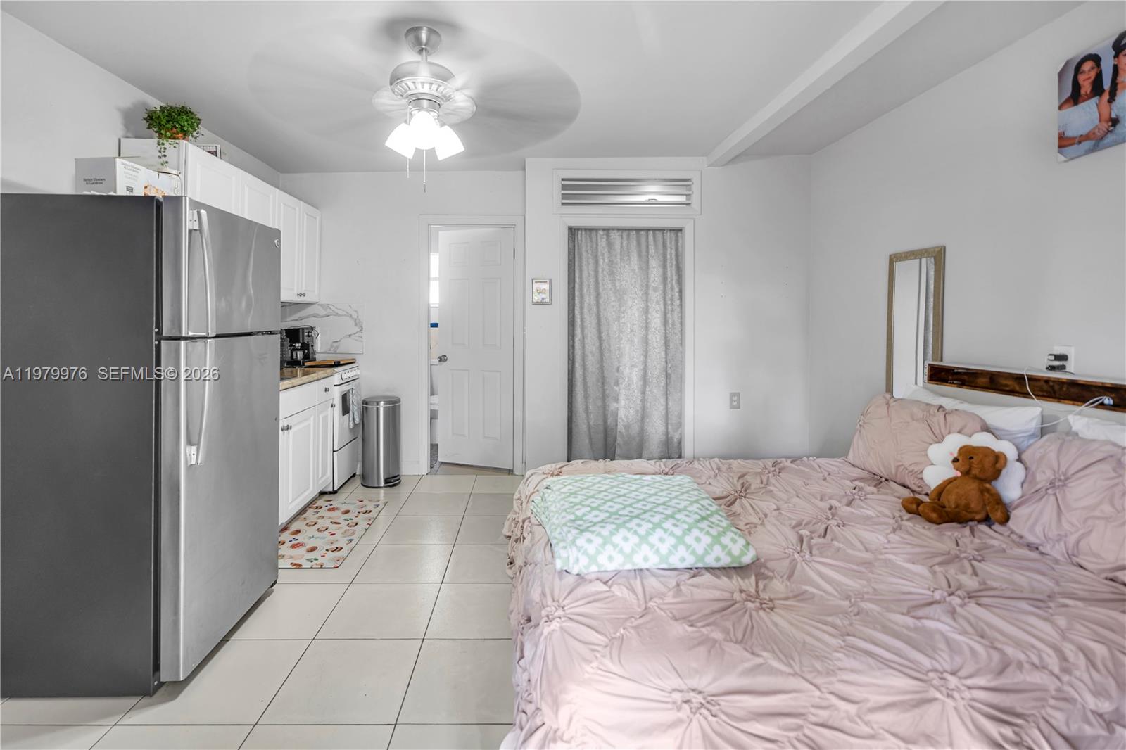 2900 Southwest 19th Street Miami, FL 33145 - Photo 17 of 24 a bedroom with a bed and a chandelier