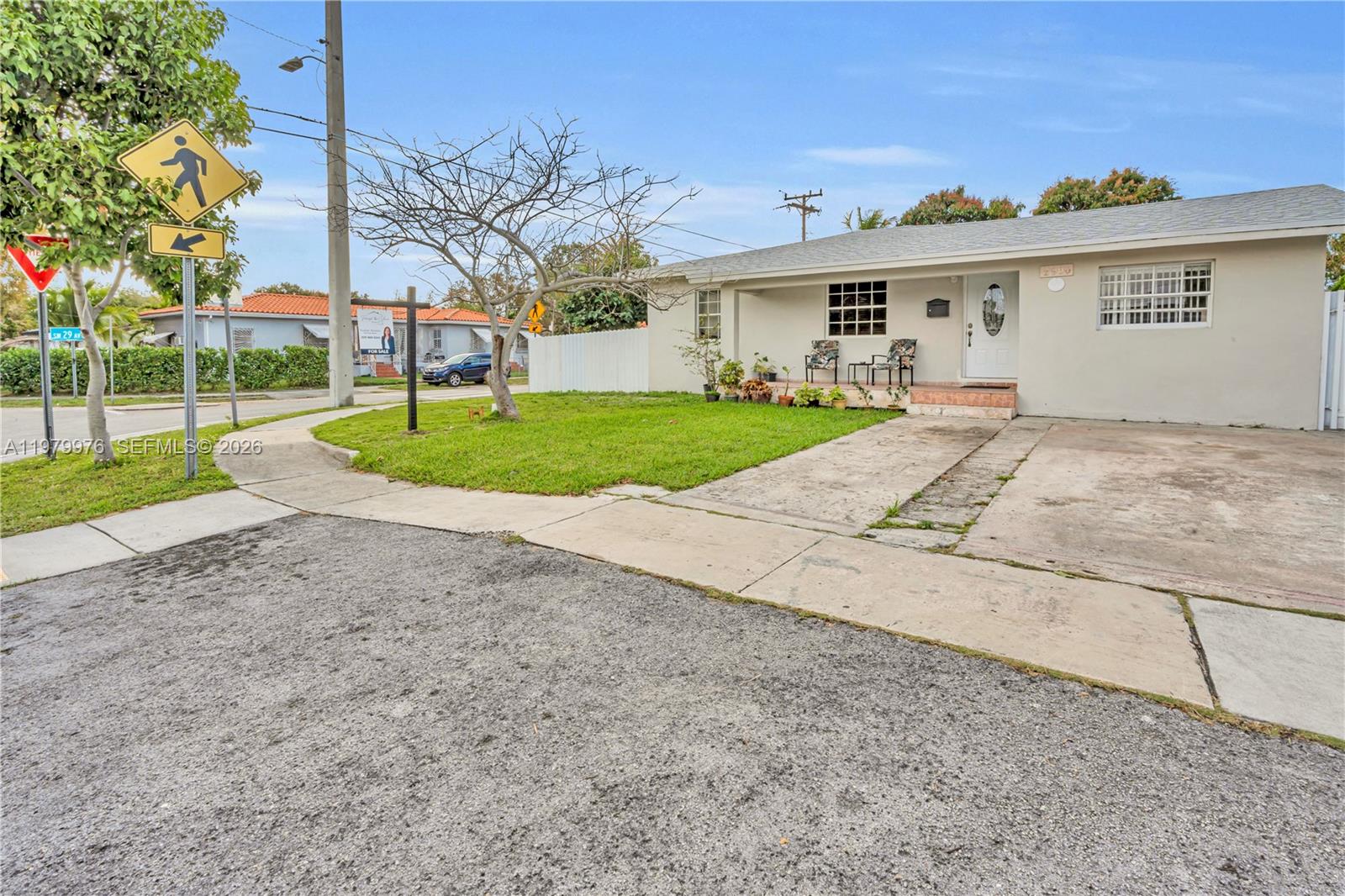 2900 Southwest 19th Street Miami, FL 33145 - Photo 3 of 24 a view of a white house with a yard and potted plants