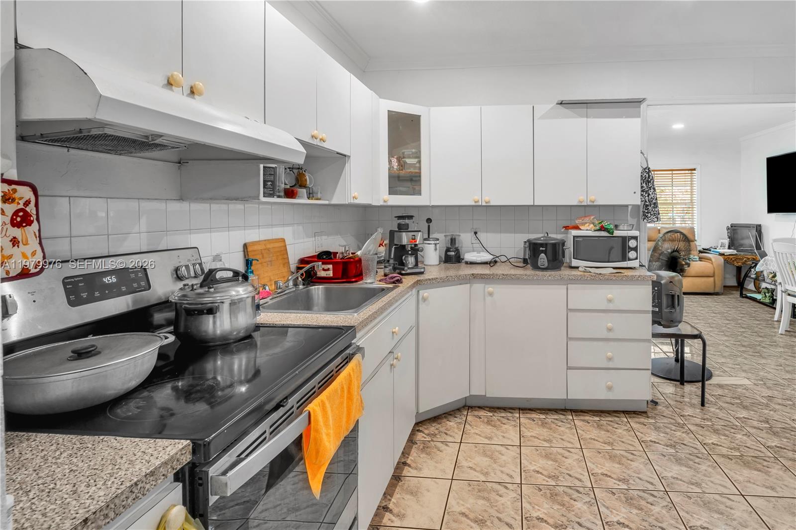2900 Southwest 19th Street Miami, FL 33145 - Photo 8 of 24 a kitchen with a sink a stove and cabinets