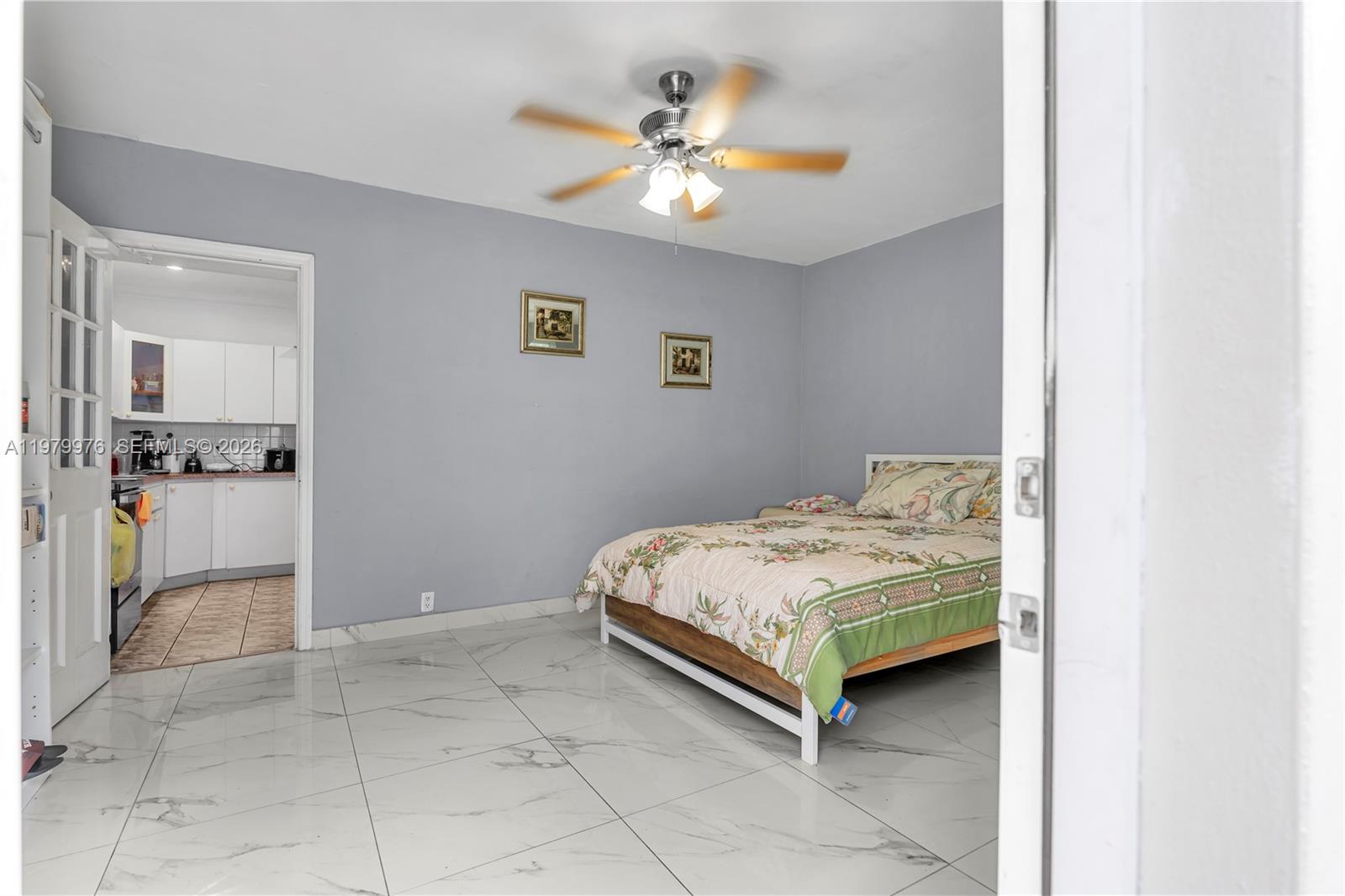 2900 Southwest 19th Street Miami, FL 33145 - Photo 10 of 24 a bedroom with a bed and a chandelier