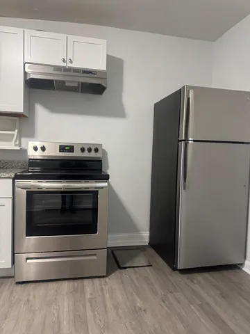 a stove top oven sitting inside of a kitchen