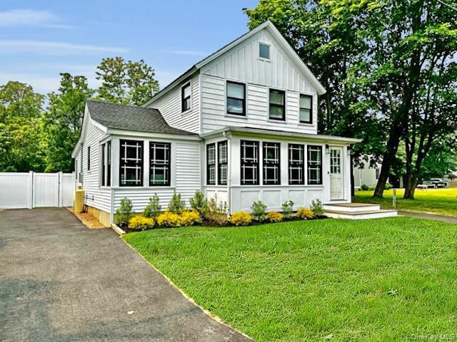 275 Sound Road Greenport, NY 11944 - Photo 13 of 33 View of front of property with driveway, board and batten siding, a front yard, and a gate