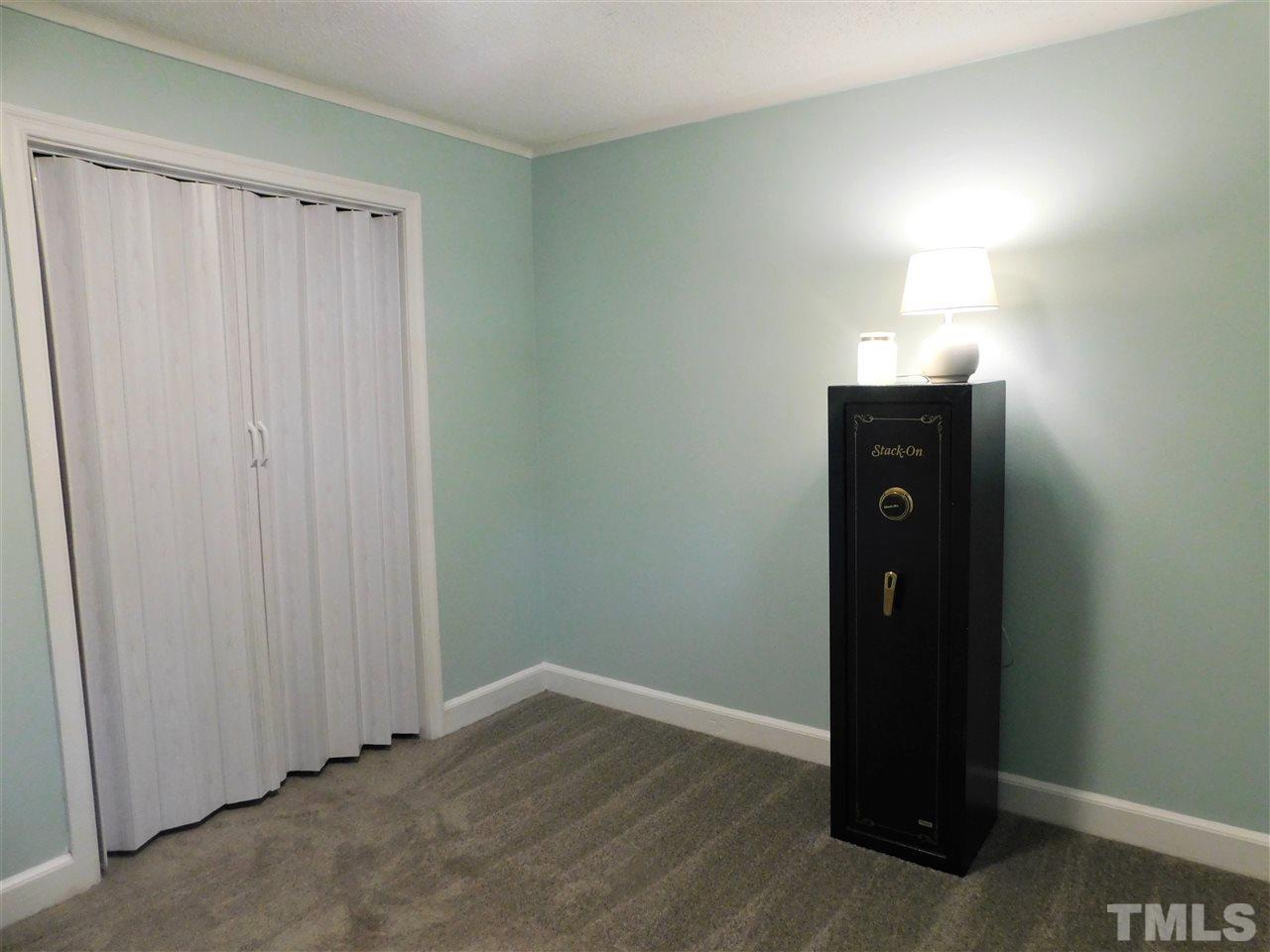 3033 Ross Road Durham, NC 27703 - Photo 13 of 30 an empty room with wooden floor and closet area
