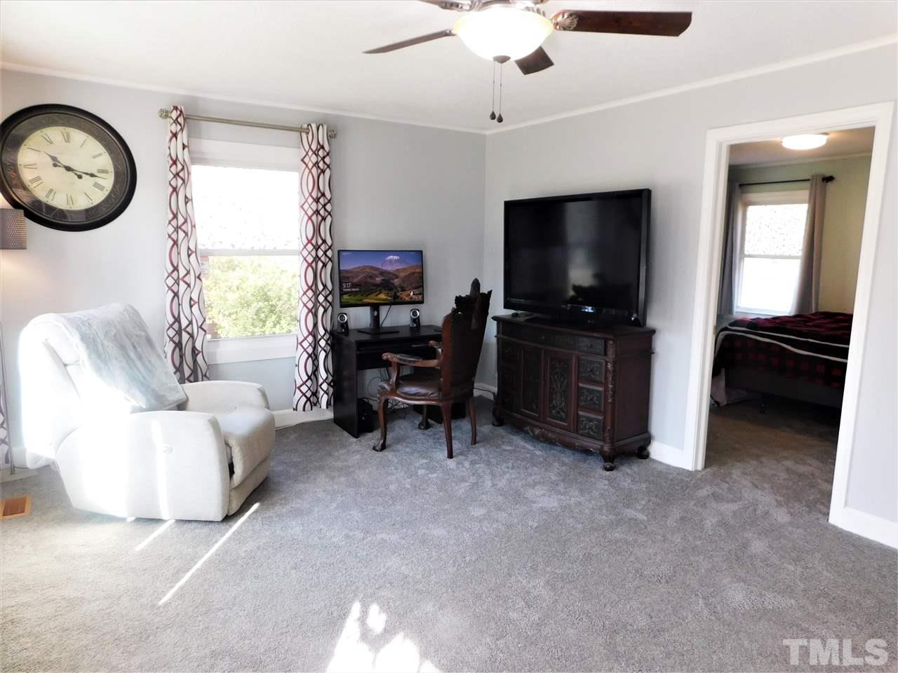 3033 Ross Road Durham, NC 27703 - Photo 16 of 30 a living room with furniture a flat screen tv and a window