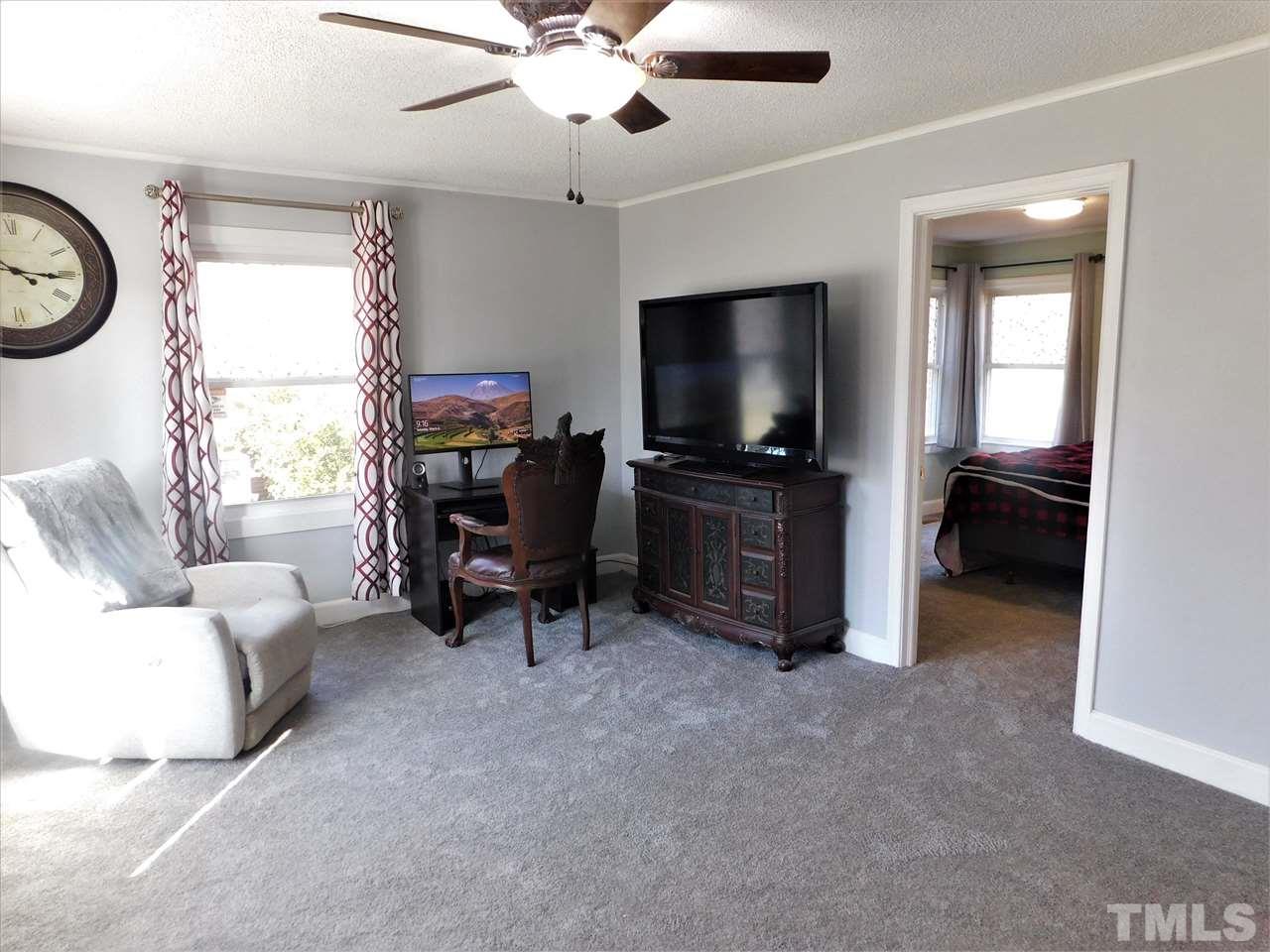 3033 Ross Road Durham, NC 27703 - Photo 18 of 30 a view of a livingroom with furniture and a flat screen tv