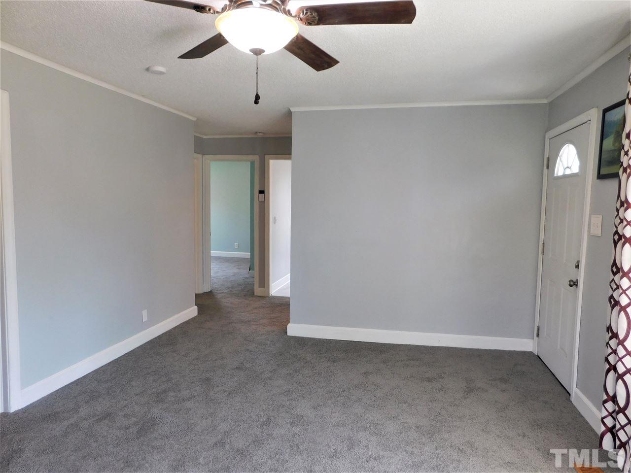 3033 Ross Road Durham, NC 27703 - Photo 19 of 30 en empty room with windows and ceiling fan
