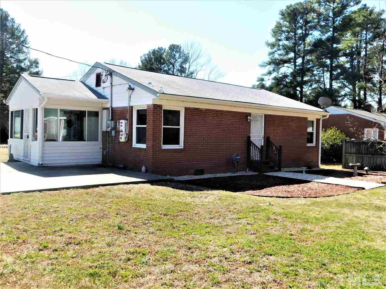3033 Ross Road Durham, NC 27703 - Photo 21 of 30 a front view of a house with yard and garage