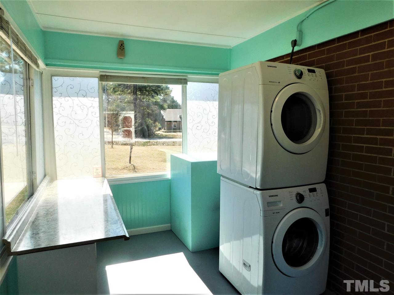 3033 Ross Road Durham, NC 27703 - Photo 4 of 30 a view of a bedroom with washer and dryer