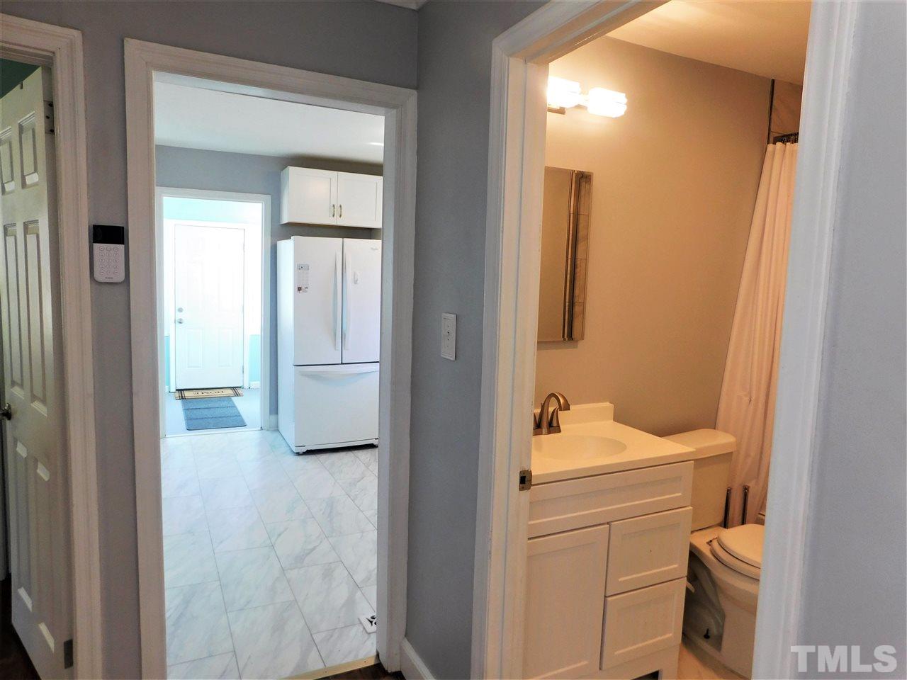 3033 Ross Road Durham, NC 27703 - Photo 7 of 30 a bathroom with a sink toilet and shower