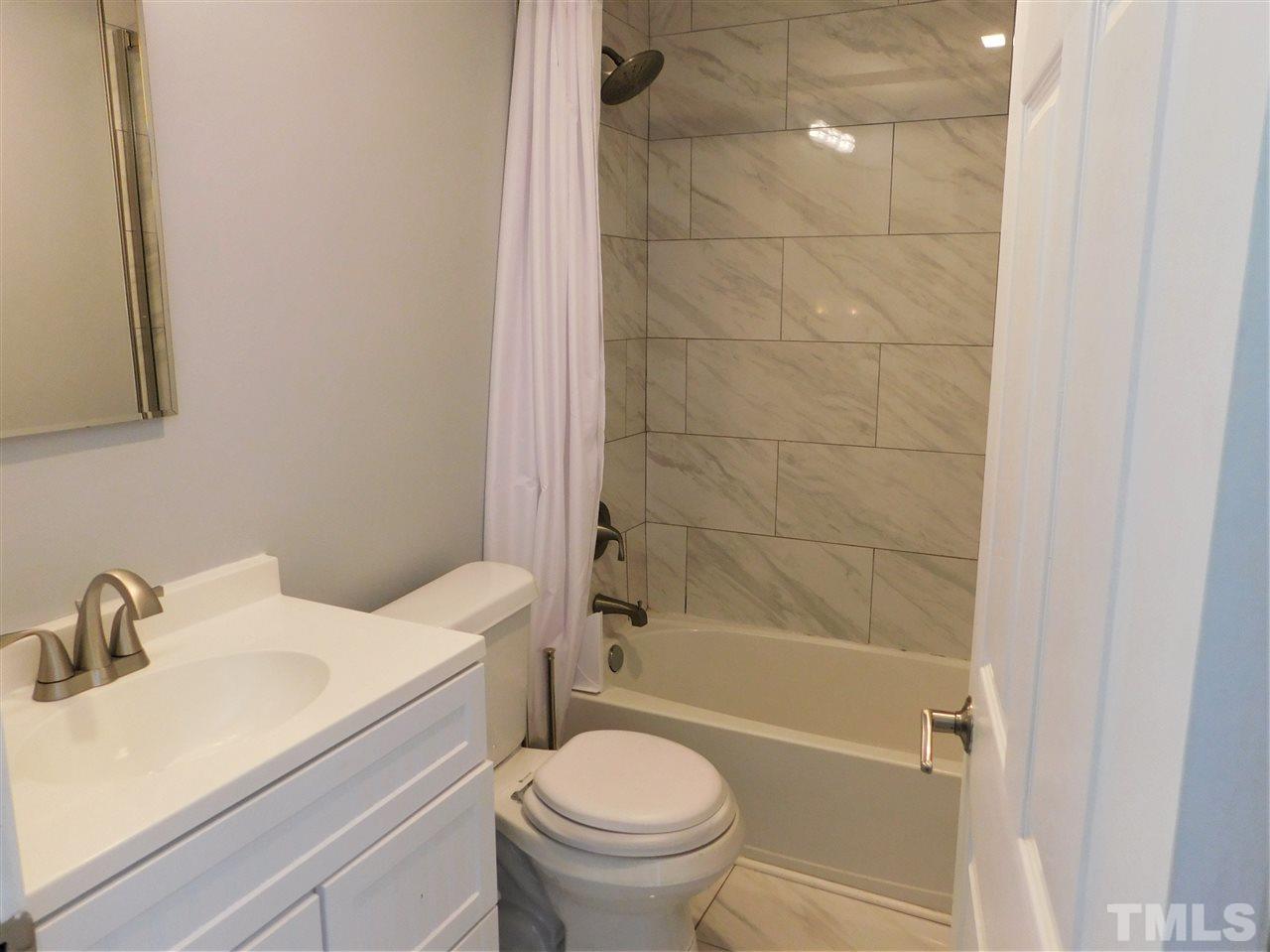 3033 Ross Road Durham, NC 27703 - Photo 8 of 30 a bathroom with a sink toilet and shower