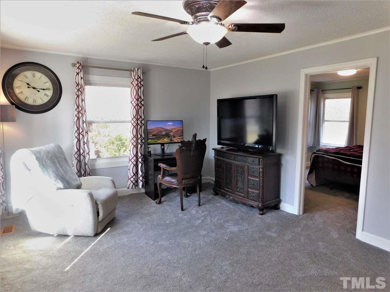 3033 Ross Road Durham, NC 27703 - Photo 10 of 30 a living room with furniture and a flat screen tv