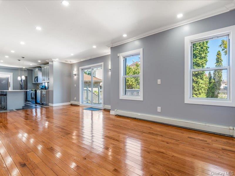 176-27 Sunbury Road Queens, NY 11434 - Photo 12 of 31 Unfurnished living room featuring crown molding, light wood-style flooring, baseboard heating, and recessed lighting