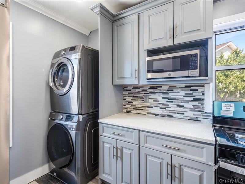 176-27 Sunbury Road Queens, NY 11434 - Photo 15 of 31 Washroom with crown molding and stacked washer / drying machine