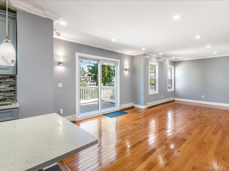 176-27 Sunbury Road Queens, NY 11434 - Photo 17 of 31 Unfurnished living room with crown molding, light wood-style floors, recessed lighting, and a baseboard radiator