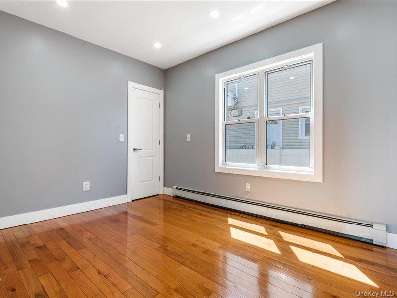 176-27 Sunbury Road Queens, NY 11434 - Photo 19 of 31 Spare room with a baseboard radiator, light wood-style flooring, and recessed lighting