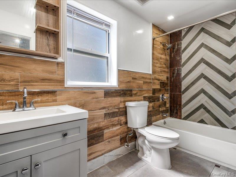 176-27 Sunbury Road Queens, NY 11434 - Photo 22 of 31 Bathroom featuring shower / washtub combination, vanity, and light tile patterned floors