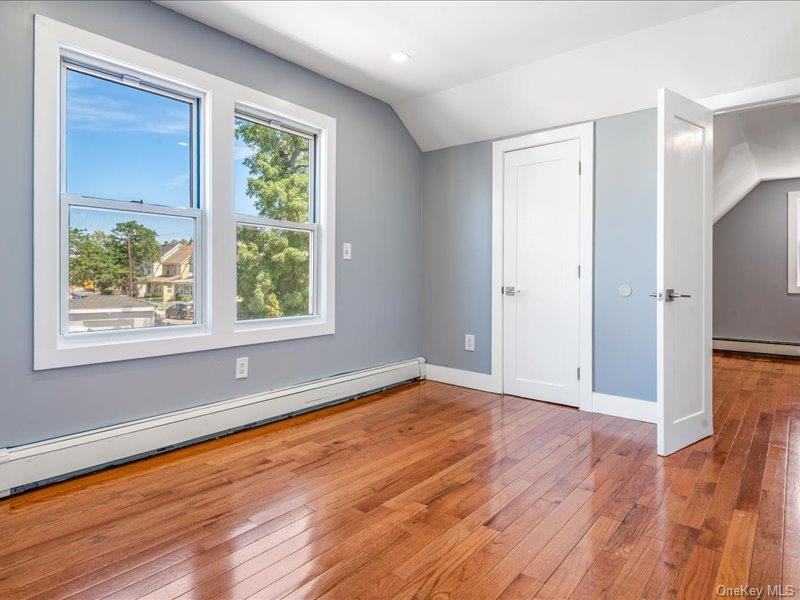 176-27 Sunbury Road Queens, NY 11434 - Photo 26 of 31 Bonus room with a baseboard heating unit, lofted ceiling, and light wood-style floors