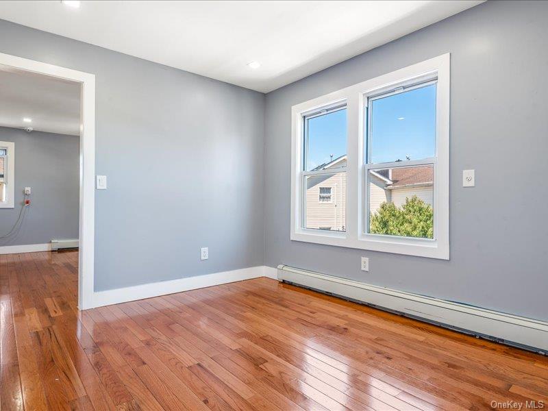 176-27 Sunbury Road Queens, NY 11434 - Photo 27 of 31 Spare room featuring light wood finished floors, baseboard heating, a baseboard radiator, and recessed lighting