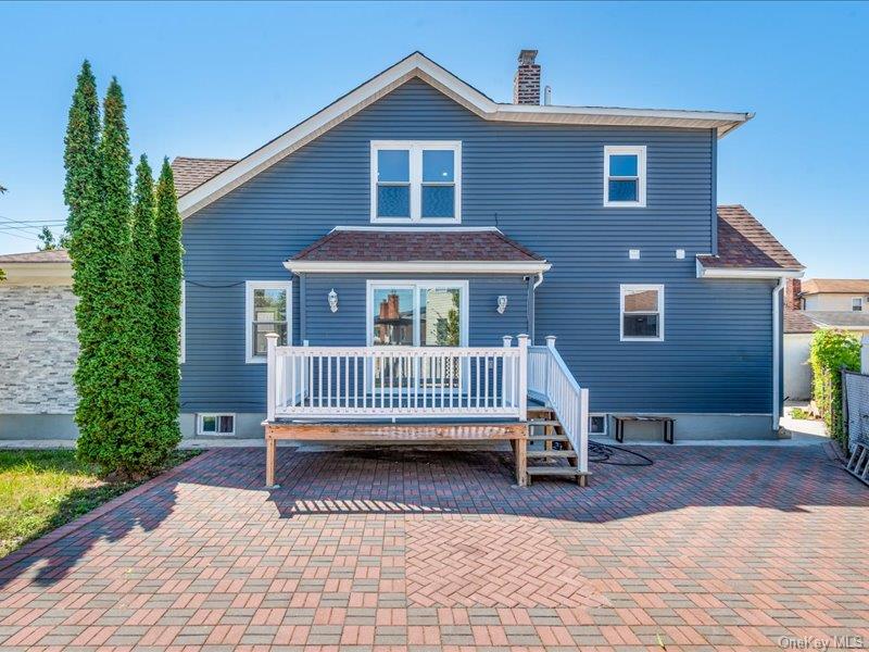 176-27 Sunbury Road Queens, NY 11434 - Photo 5 of 31 Rear view of house featuring a wooden deck, a chimney, and roof with shingles