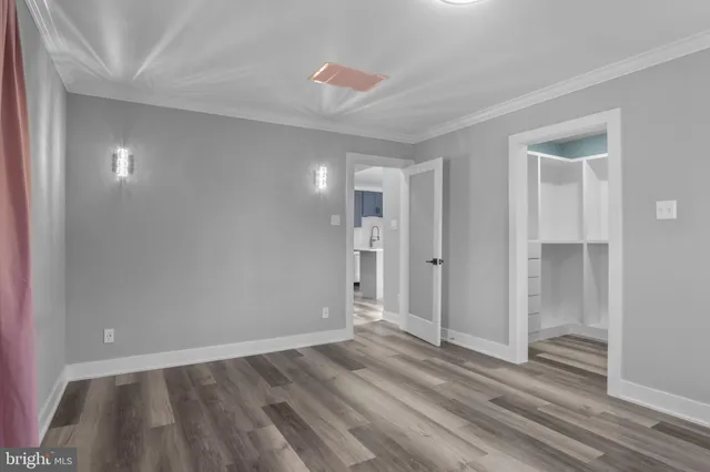 a view of wooden floor and windows in a room