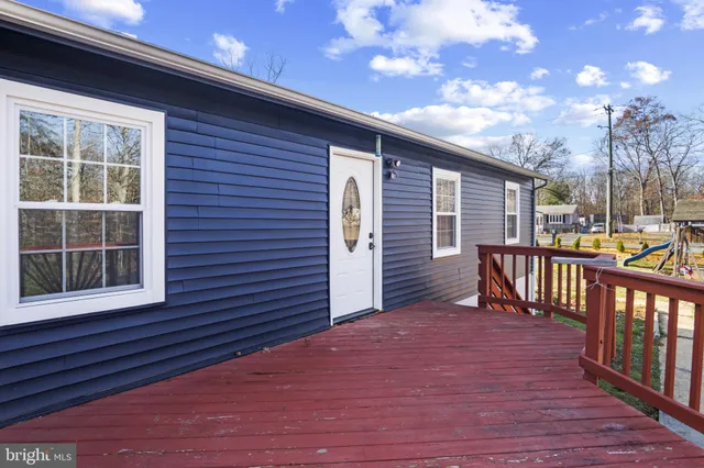 a view of backyard with deck and wooden floor