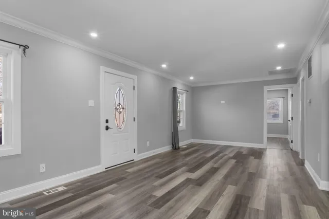 a view of hallway with wooden floor
