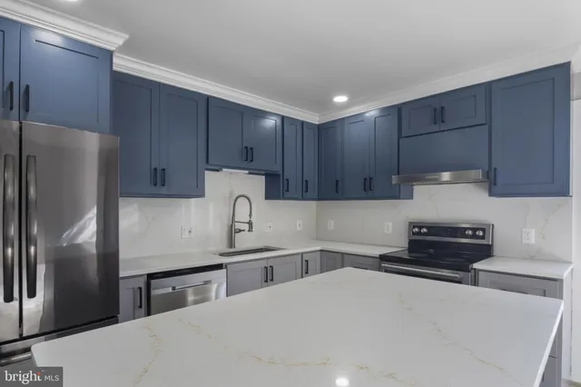a kitchen with stainless steel appliances a refrigerator sink and cabinets