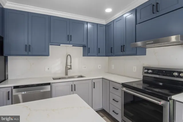 a kitchen with a sink stove and cabinets