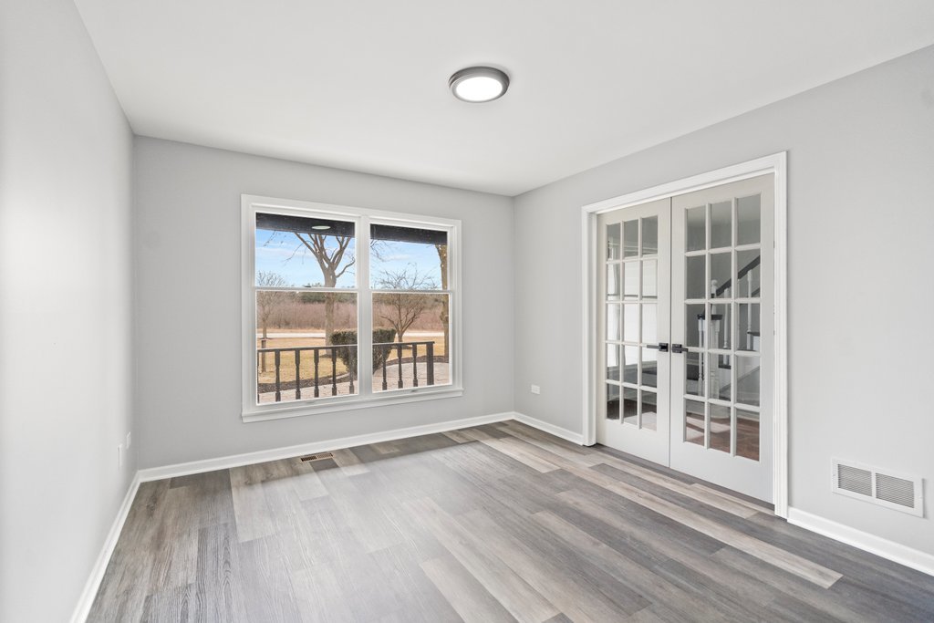 4632 West Offner Road Monee, IL 60449 - Photo 34 of 116 an empty room with wooden floor and windows