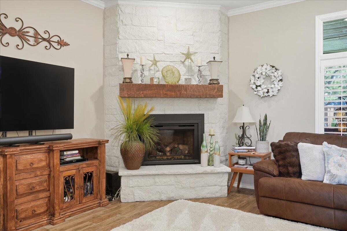 4612 100th Street Lubbock, TX 79424 - Photo 11 of 55 a living room with furniture a flat screen tv and a fireplace