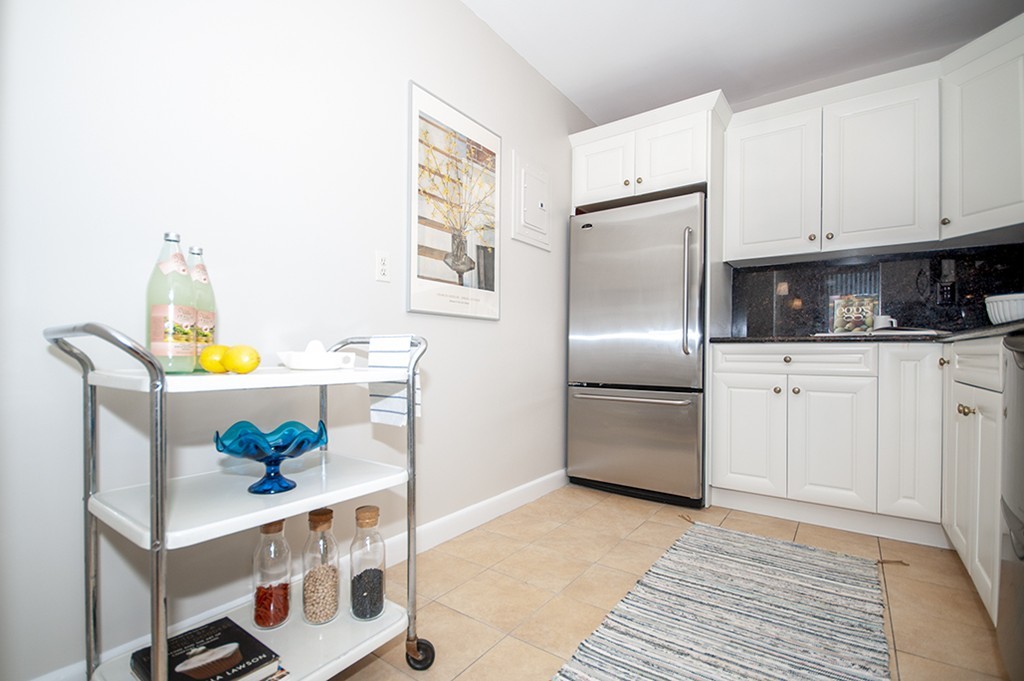 41 Park Street, Unit 207 Brookline, MA 02446 - Photo 11 of 25 a kitchen with stainless steel appliances cabinets and a counter top space