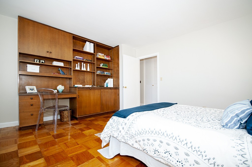 41 Park Street, Unit 207 Brookline, MA 02446 - Photo 14 of 25 a bedroom with a bed and cabinets
