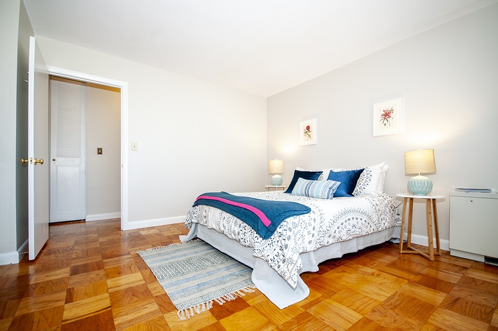 41 Park Street, Unit 207 Brookline, MA 02446 - Photo 15 of 25 a bedroom with a bed and a lamp