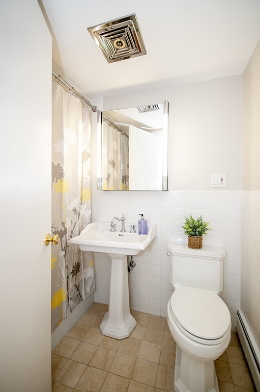 41 Park Street, Unit 207 Brookline, MA 02446 - Photo 16 of 25 a bathroom with a sink mirror and toilet