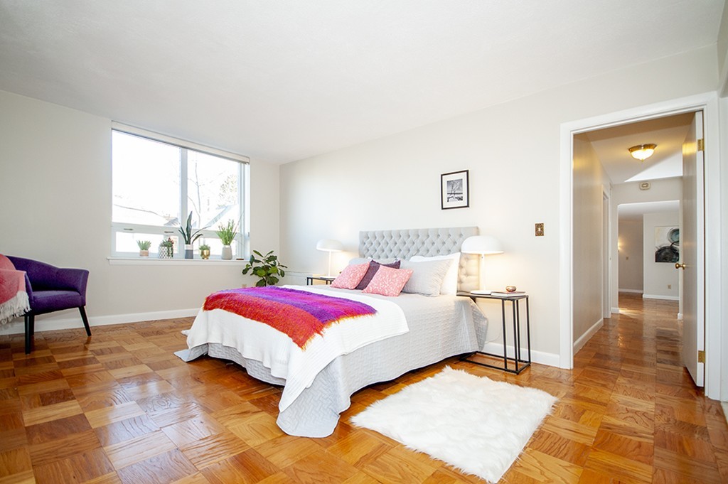 41 Park Street, Unit 207 Brookline, MA 02446 - Photo 18 of 25 a bed room with a bed and a chair