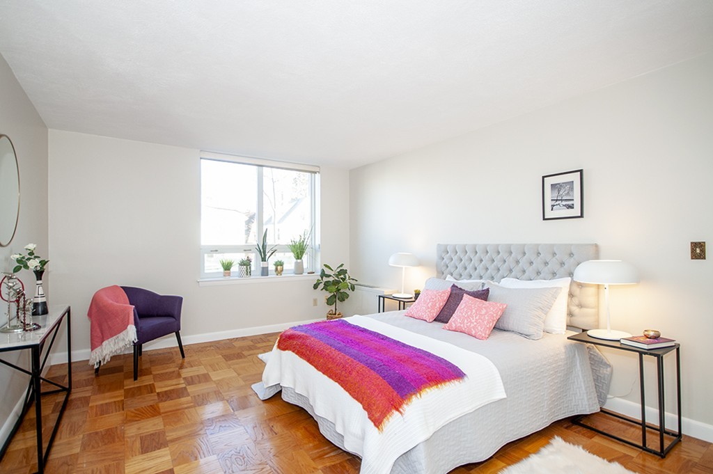 41 Park Street, Unit 207 Brookline, MA 02446 - Photo 19 of 25 a bed room with a bed and a chair