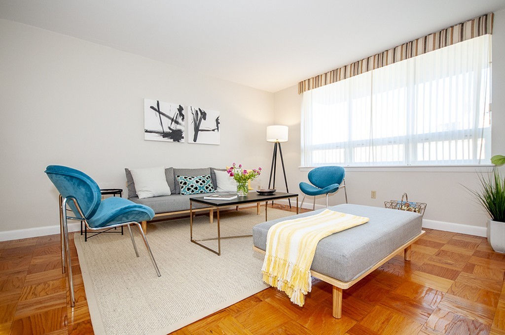 41 Park Street, Unit 207 Brookline, MA 02446 - Photo 2 of 25 a bedroom with a bed and a table in it