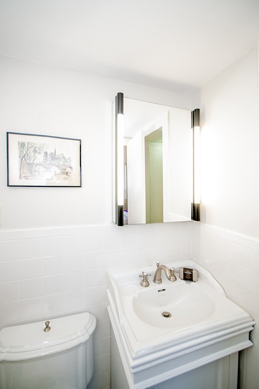 41 Park Street, Unit 207 Brookline, MA 02446 - Photo 22 of 25 a bathroom with a sink and a mirror