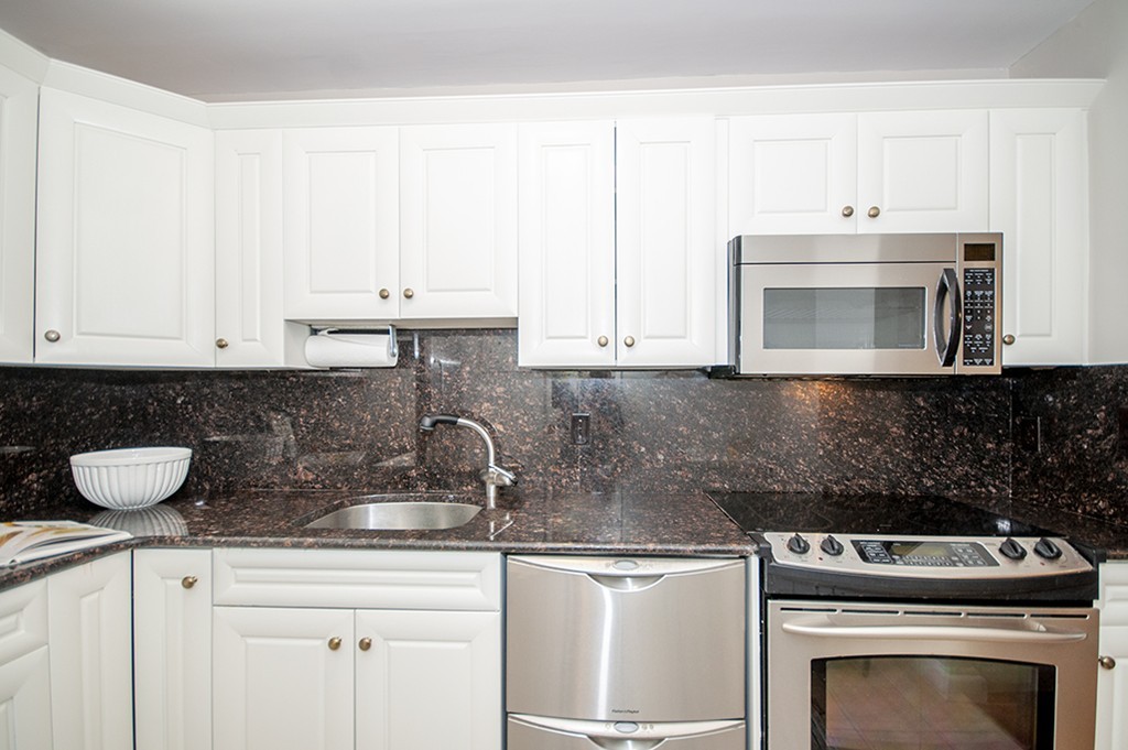 41 Park Street, Unit 207 Brookline, MA 02446 - Photo 9 of 25 a kitchen with a sink and cabinets