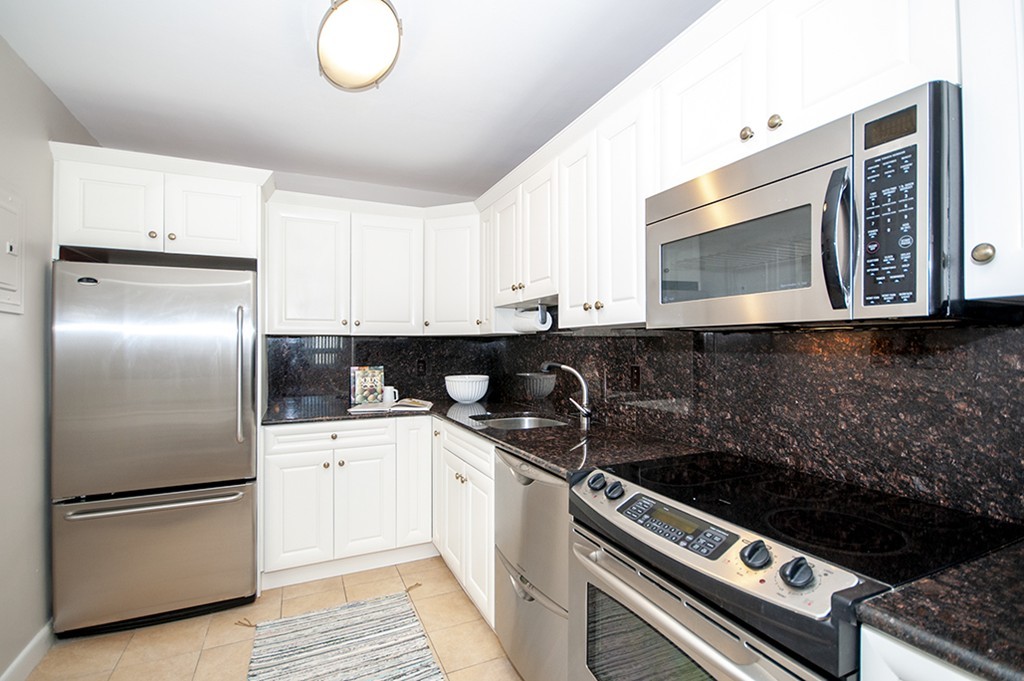41 Park Street, Unit 207 Brookline, MA 02446 - Photo 10 of 25 a kitchen with a sink stainless steel appliances and cabinets