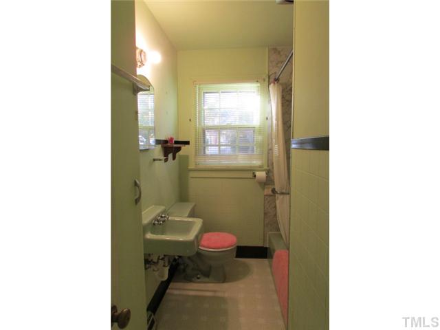 314 Semora Road Roxboro, NC 27573 - Photo 14 of 20 a bathroom with a sink and mirror with toilet