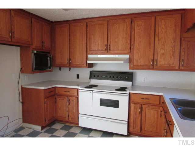 314 Semora Road Roxboro, NC 27573 - Photo 3 of 20 a kitchen with stainless steel appliances granite countertop wooden cabinets a stove a sink and dishwasher