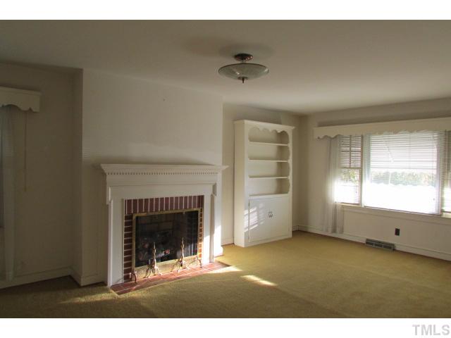 314 Semora Road Roxboro, NC 27573 - Photo 8 of 20 a view of an empty room with a fireplace and window